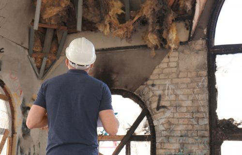 Insurance adjuster inspecting abandoned building